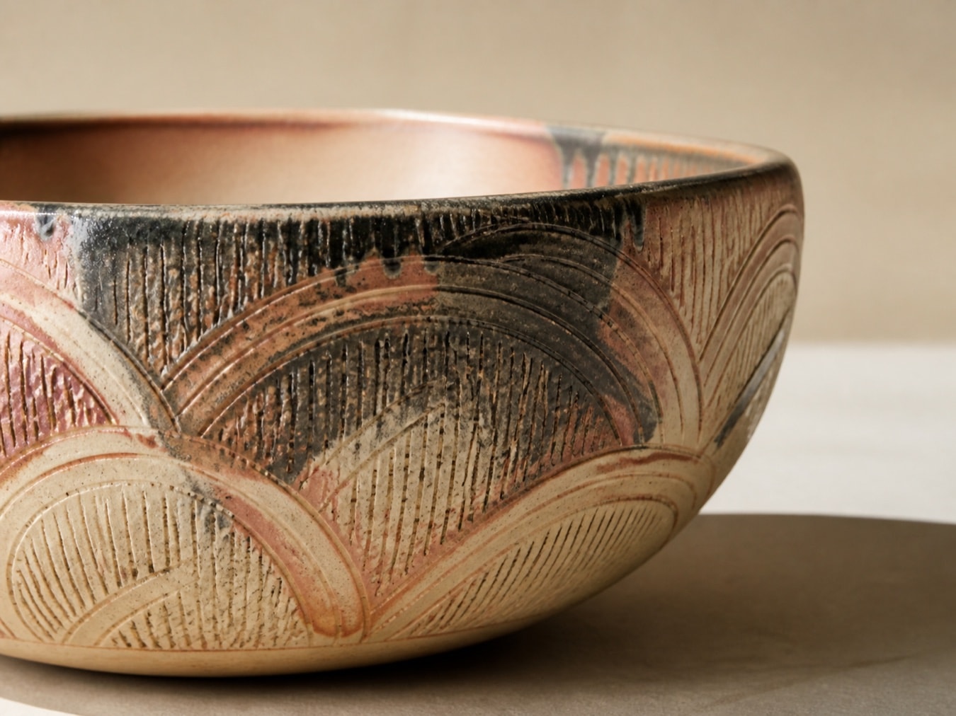close view of a generic decorated bowl with repeating arcs and carved marks